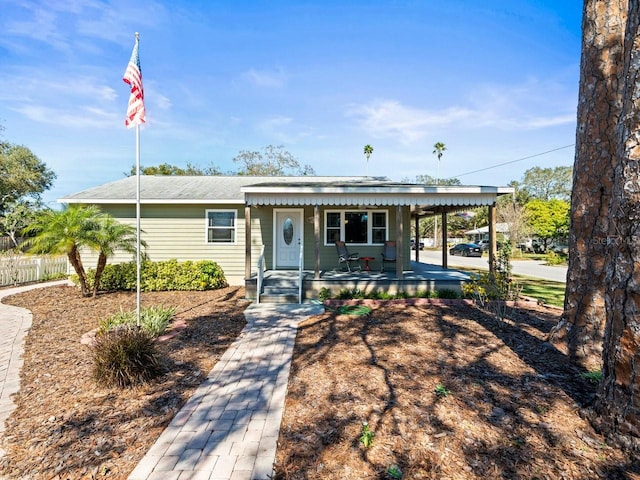 view of front of house featuring a porch and fence