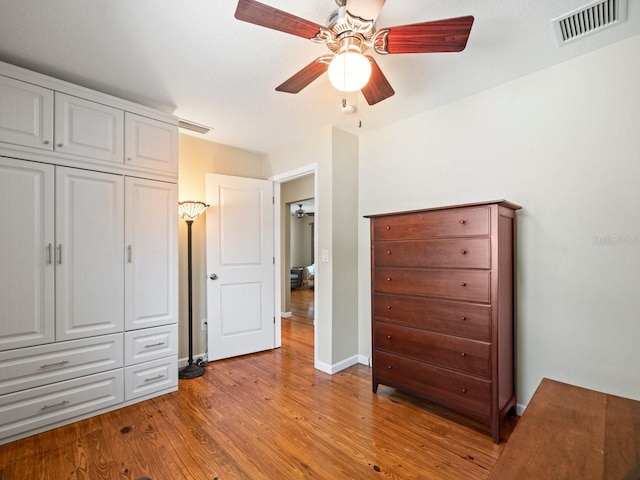 unfurnished bedroom with light wood-style flooring, a closet, visible vents, and baseboards