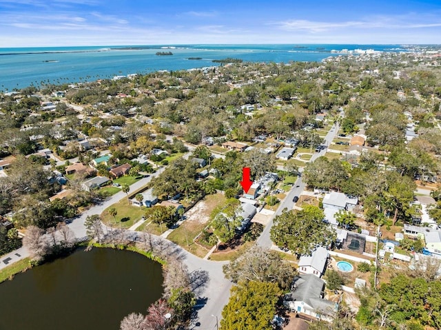 aerial view of property's location with a large body of water and nearby suburban area