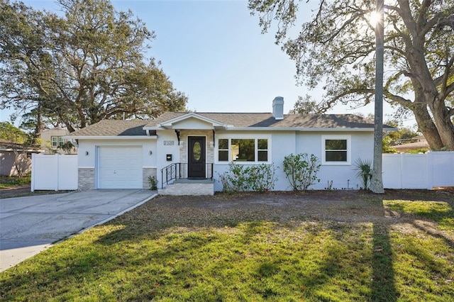 ranch-style home with a front lawn and a garage