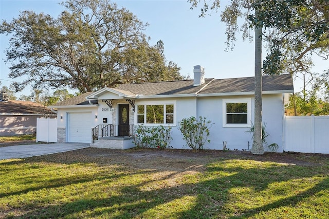 single story home featuring a front lawn and a garage