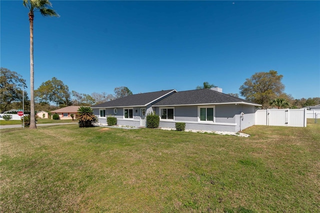 single story home featuring a chimney, stucco siding, a gate, fence, and a front lawn