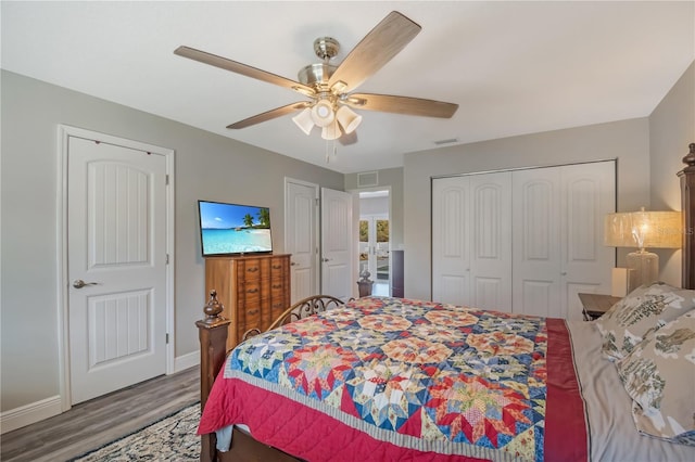 bedroom featuring ceiling fan, visible vents, a closet, and wood finished floors