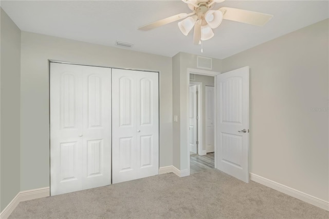 unfurnished bedroom featuring a closet, carpet flooring, and visible vents