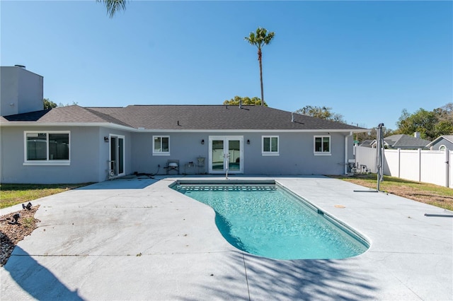 view of swimming pool featuring french doors, a patio area, fence, and a fenced in pool