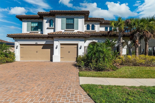 mediterranean / spanish-style house with a garage