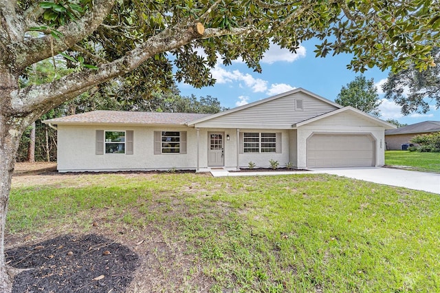 ranch-style house with a garage, stucco siding, driveway, and a front yard