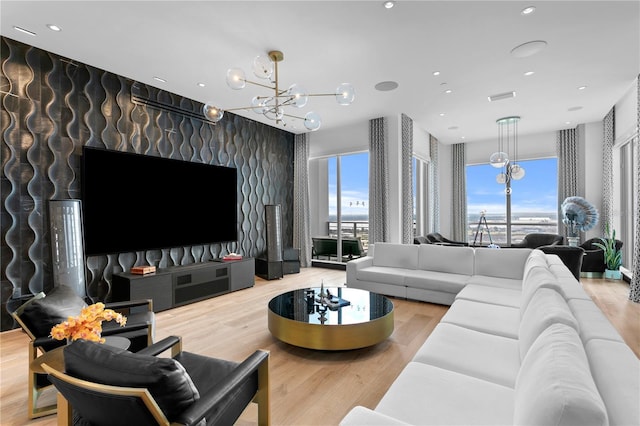 living room with hardwood / wood-style floors and an inviting chandelier