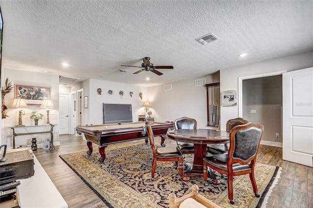 dining area featuring visible vents, ceiling fan, and hardwood / wood-style floors