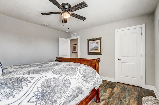 bedroom featuring dark wood-type flooring, a ceiling fan, visible vents, and baseboards