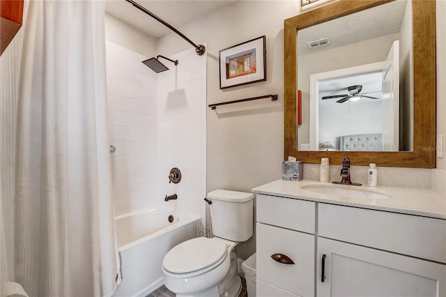 full bathroom featuring ceiling fan, toilet, vanity, visible vents, and shower / tub combo with curtain