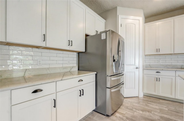 5618 Winterbrook Way, Winter Park, FL 32792 - kitchen with stainless steel refrigerator with ice dispenser, white cabinets, backsplash, light stone countertops, and light wood-style flooring