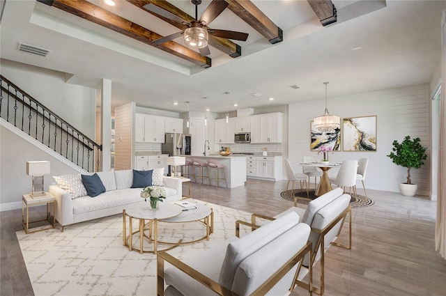 5618 Winterbrook Way, Winter Park, FL 32792 - living room featuring ceiling fan, light wood-type flooring, beamed ceiling, recessed lighting, and a tray ceiling