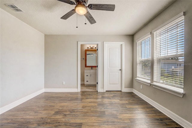 5618 Winterbrook Way, Winter Park, FL 32792 - unfurnished bedroom featuring wood finished floors, connected bathroom, and a ceiling fan