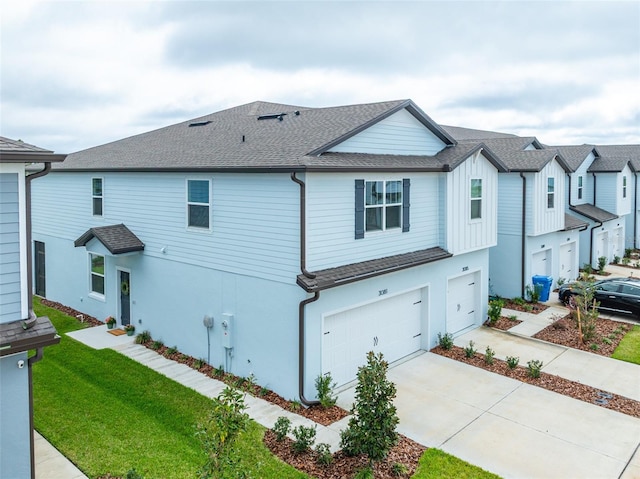 view of property featuring a garage, a shingled roof, a front lawn, and stucco siding