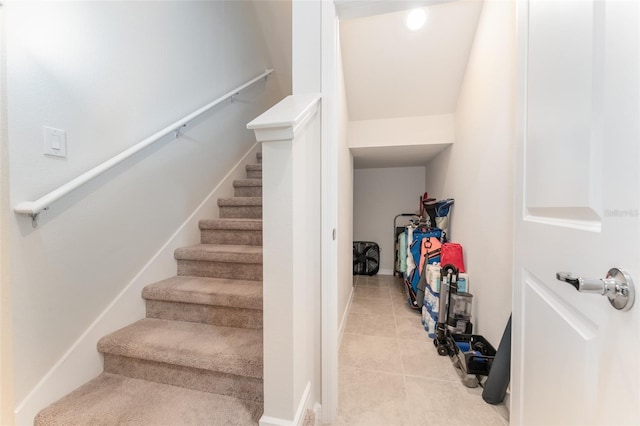 stairway featuring tile patterned flooring