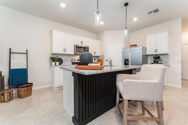 kitchen with white cabinetry, visible vents, appliances with stainless steel finishes, and backsplash