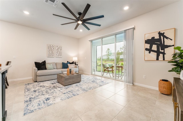 living room featuring light tile patterned flooring, baseboards, visible vents, and recessed lighting