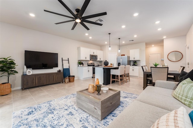 living area featuring light tile patterned floors, recessed lighting, visible vents, ceiling fan, and baseboards