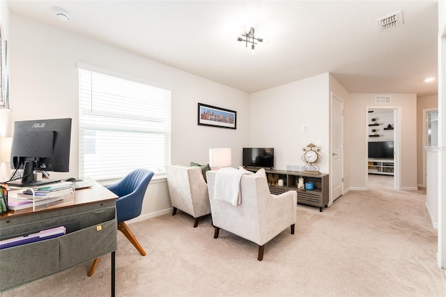 home office with baseboards, visible vents, and light colored carpet