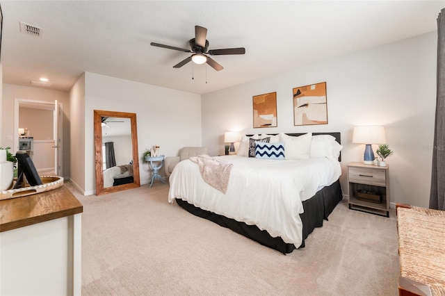 bedroom featuring ceiling fan, visible vents, baseboards, and light colored carpet