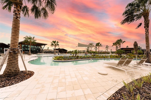 community pool with a gazebo and a patio