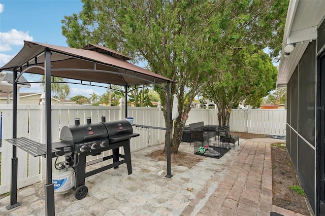 view of patio / terrace featuring a fenced backyard, a gazebo, and area for grilling