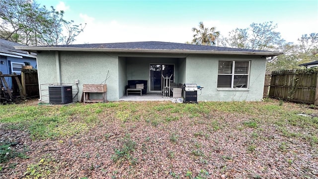 rear view of house featuring a patio, fence, cooling unit, and stucco siding