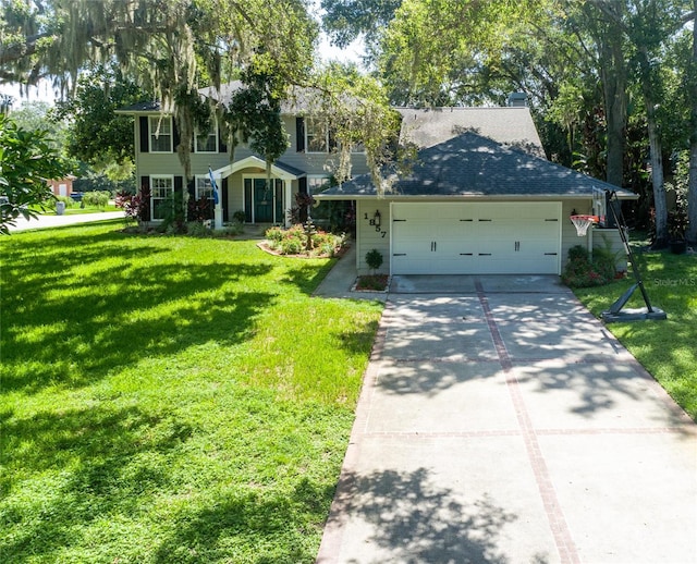 view of front of home with driveway, an attached garage, and a front lawn