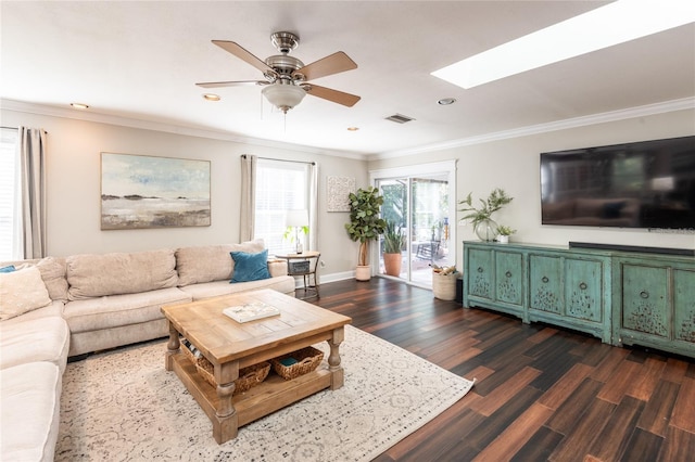 living room with a skylight, visible vents, a ceiling fan, ornamental molding, and dark wood-style floors