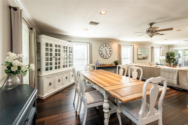 dining room with dark wood-style floors, visible vents, ornamental molding, and ceiling fan