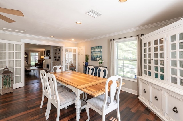 dining room featuring dark wood-style floors, a fireplace, recessed lighting, visible vents, and ornamental molding