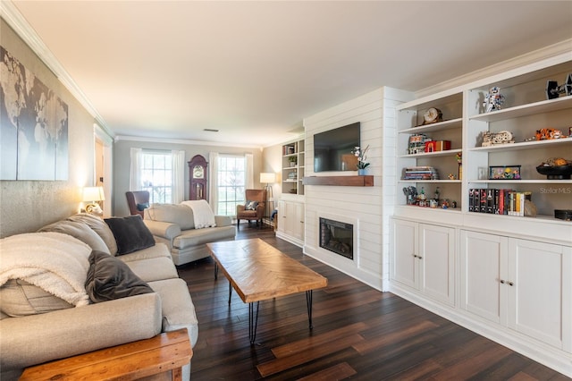 living area featuring dark wood-style floors, a large fireplace, and crown molding