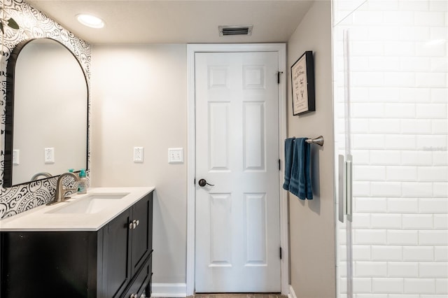 bathroom featuring visible vents, vanity, and baseboards