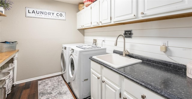 laundry room with separate washer and dryer, a sink, baseboards, cabinet space, and dark wood-style floors