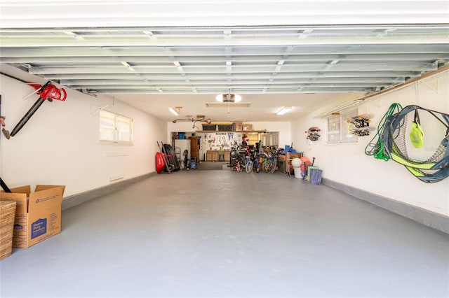 garage with a garage door opener and baseboards