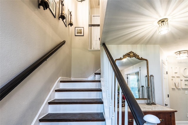 stairway featuring baseboards