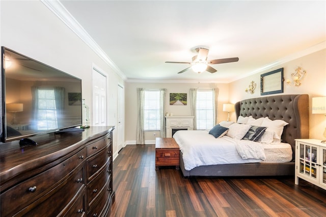 bedroom with multiple windows, ornamental molding, and dark wood finished floors