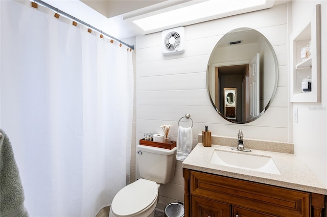 full bath featuring toilet, vanity, and visible vents