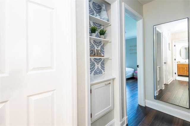 interior space featuring dark wood finished floors and baseboards