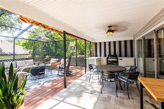 view of patio / terrace with glass enclosure, grilling area, an outdoor hangout area, exterior kitchen, and outdoor dining space