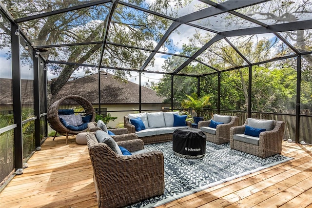 exterior space featuring a lanai, an outdoor living space, and a wooden deck