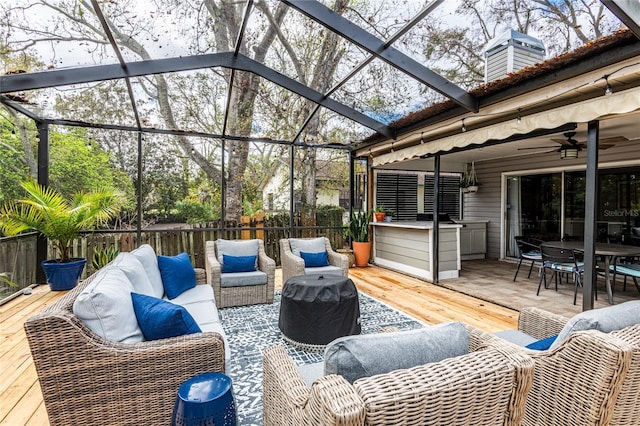 view of patio featuring a deck, outdoor dining area, fence, and an outdoor living space