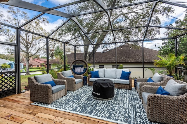 wooden deck with glass enclosure and an outdoor hangout area