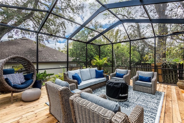 wooden terrace featuring a lanai and outdoor lounge area