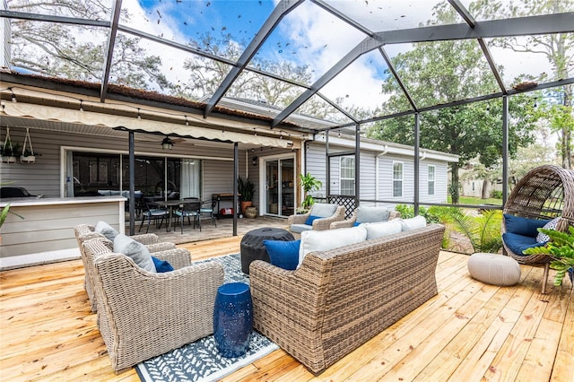 wooden terrace featuring a lanai and outdoor lounge area