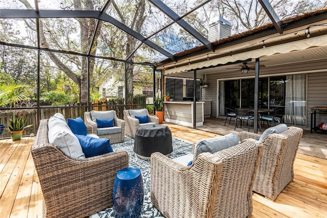 wooden deck featuring a ceiling fan, outdoor dining space, fence, and an outdoor hangout area