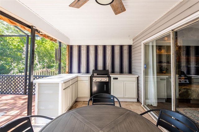 view of patio with area for grilling, an outdoor kitchen, and a ceiling fan