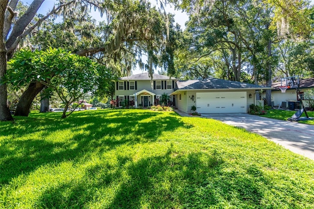 view of front of property with a front yard, concrete driveway, and an attached garage