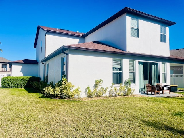 back of house with a yard and a patio area